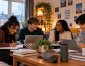 Edge Hill University students working together on assignments in their shared student accommodation before Christmas